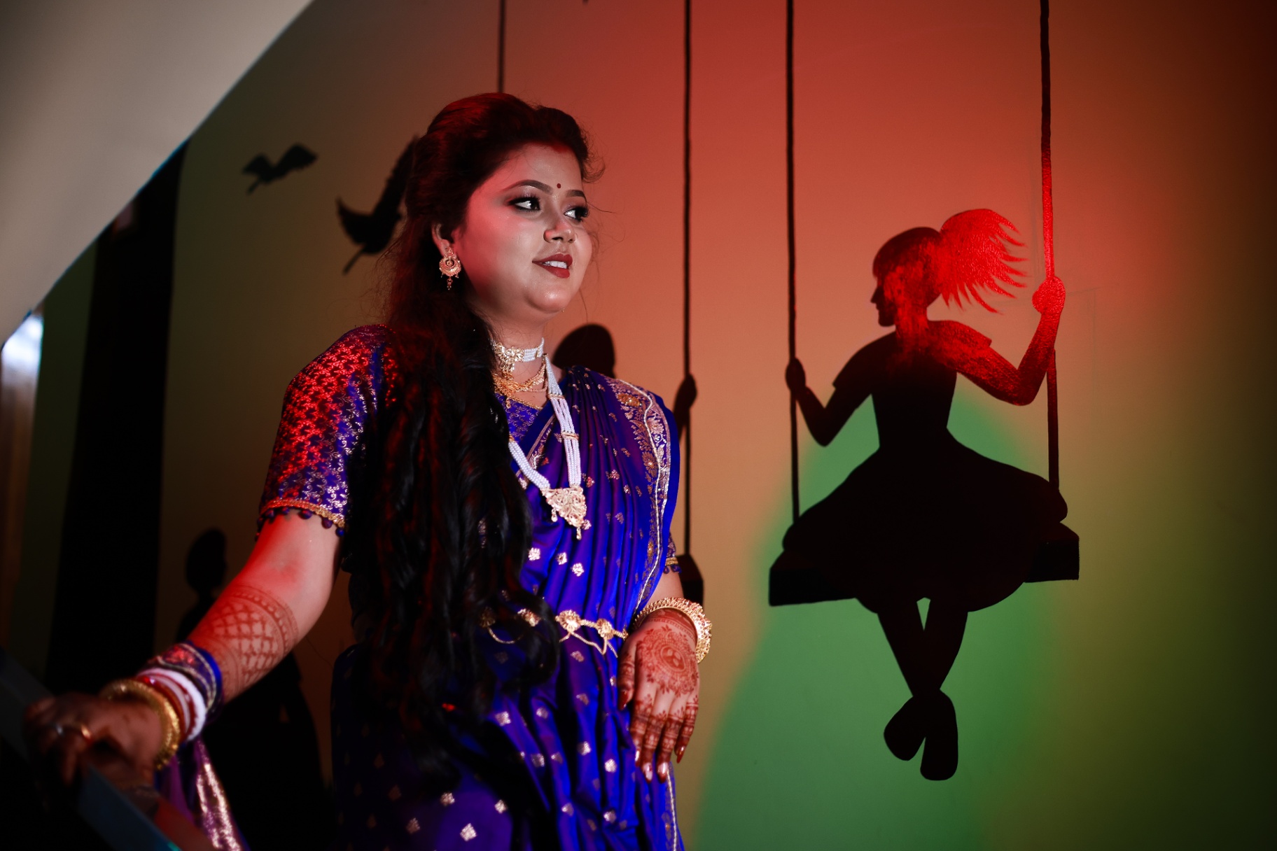 Bride in blue saree with dramatic wall art
